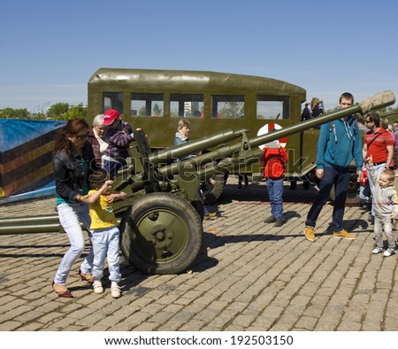 MOSCOW - MAY 9, 2014: Holiday Victory Day devoted to victory in Second World War, children play on exhibition of vintage military technique on memorial Poklonnaya hill.