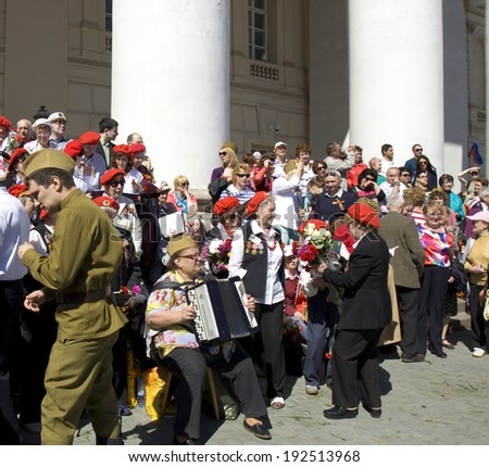 MOSCOW - MAY 9, 2014: Holiday Victory Day devoted to victory in Second World War, people sing war songs on steps of Big Theatre.