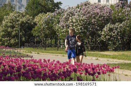 MOSCOW - MAY 16, 2014: people resting in park Lilac garden, garden has been opened in 1954 and has many unique sorts of lilac, selected for this garden and sold all over the world.