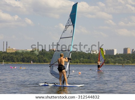 MOSCOW - JUNE 27, 2010: members of windsurfing school in district Strogino train on Moscow-river to Russian and world competitions.