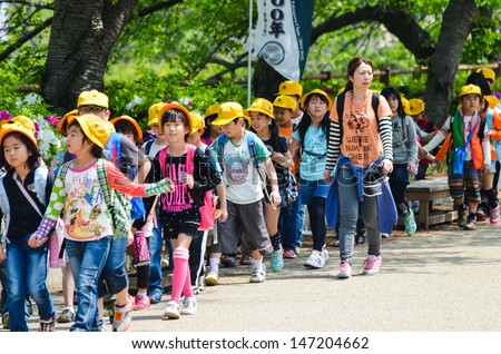 OSAKA,JAPAN - APRIL 26 :Japanese elementary school taking students on a fieldtrip to Osaka Castle  Every students must wear a colorful hat when stay outside the school. April 26 ,2013 in Osaka , Japan