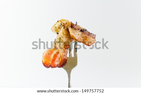 Closeup of cooked bacon on a fork