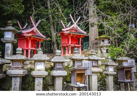 NARA,JAPAN - 5 APRIL , 2014 :Path leading up to Kasuga Taisha shrine, braced by rows of stone lanterns . The lanterns are lit twice a year on the occasion of the Lantern Festivals.