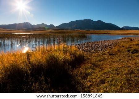 Lake towards the sun with mountains in background
