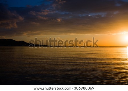 Beautiful view of the Golden sunset, sun, clouds, sea and the island. Spain, Mallorca