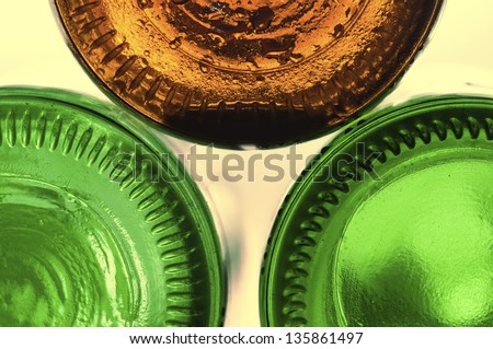 group of bottom beers bottle saucer a close-up group of bottle beers bottom / saucer. (green brown)