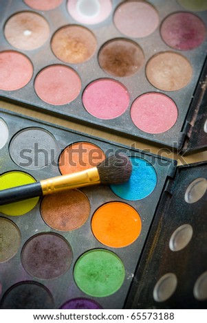 A set of eye shadows with cosmetic brush