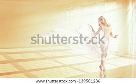 beautiful blonde ballerina is dancing in a transparent dress in a large hall in the sun
