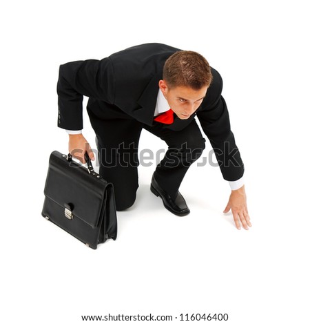 Young Businessman Crouching, Getting Ready To Run The Race Stock Photo ...