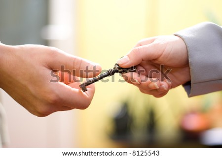Hands exchanging the key to success