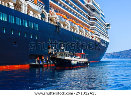 SANTORINI, GREECE- JUNE 14: Zuiderdam cruise ship anchoring in Mediterranean sea to transfer passengers to visit Santorini island, Greece on June 14, 2015.