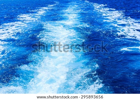 Boat wake prop wash on blue ocean, mediterranean sea.