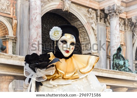 VENICE, ITALY - FEBRUARY 8: Unidentified people in a mask and colourful costume at St. Mark\'s Square participates in the Carnival of Venice, Italy on February 8, 2015.