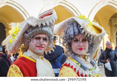 VENICE, ITALY - FEBRUARY 8: Unidentified people in masks and colourful costumes at St. Mark\'s Square participate in the Carnival of Venice, Italy on February 8, 2015.