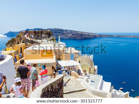 SANTORINI, GREECE- JUNE 14: Many tourists visiting beautiful city of Oia on Santorini island in Greece on June 14, 2015. Santorini is one of the most popular tourist destinations in Greece.