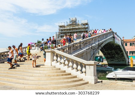 VENICE, ITALY- JULY 21: People crossing Grand canal on the bridge near by Train station Venezia Santa Lucia in Venice, Italy on July 21, 2015.