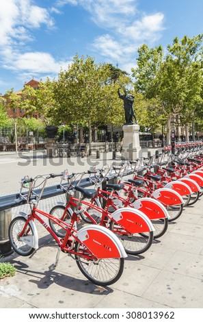 BARCELONA, SPAIN - AUGUST 13, 2015: City bicycles parking in city park of Barcelona, Spain on August 13, 2015. Bicycling is very popular transportation in city of Barcelona.