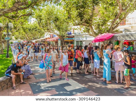 SAINT-RAPHAEL, FRANCE- AUGUST 16: Bars and restaurants by coastline of French riviera of Saint-Raphael was crowded by tourists on August 16, 2015.