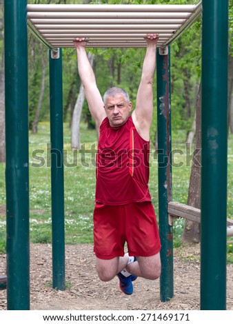 Senior Exercising In Sport Park