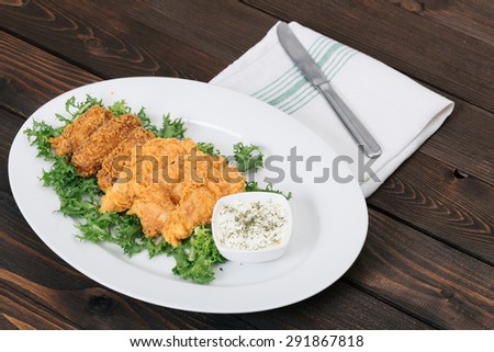 Fried chicken on the wooden table. Selective focus and small depth of field.