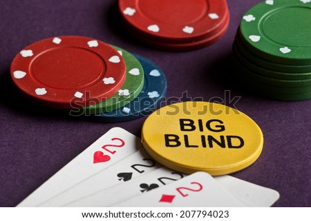 Poker set with chips and cards on the table - big blind chip.