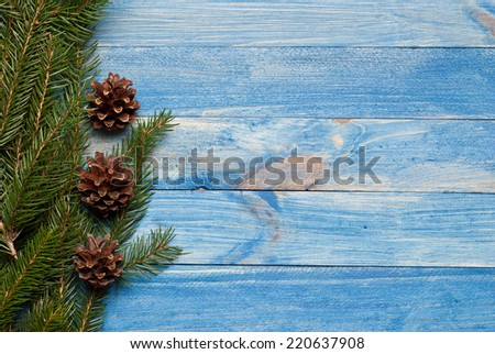Christmas rustic background - vintage blue planked wood with tree twig and free text space