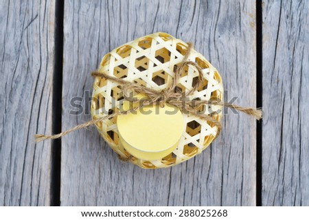 Natural bamboo basket packaging with tag on wood background .