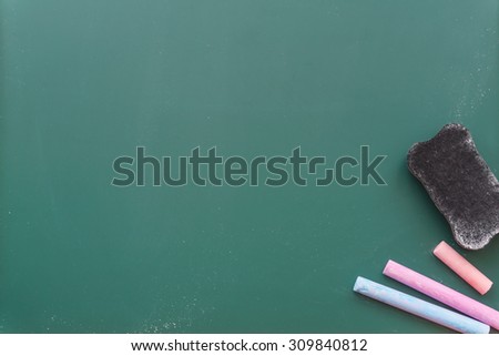 Chalkboard, blackboard with colored chalks and eraser for background.