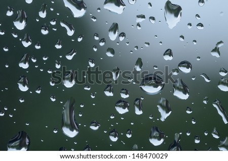 Close up or Macro image of rain drops on a window during a rain storm.