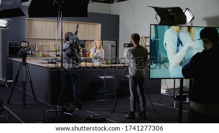 WIDE Behind the scenes of studio set, shooting TV television cooking show featuring celebrity chef, professional TV production