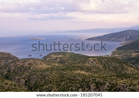 Amazing view from the top of a mountain down to the sea, close to Itea, Greece, at dusk