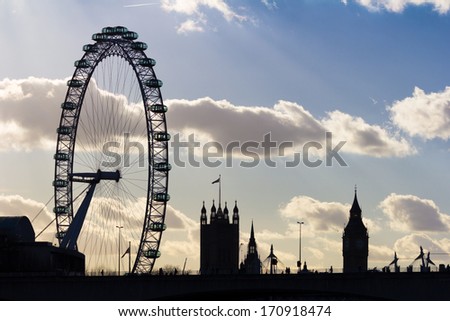 LONDON, UK - JANUARY 11, 2014: The London Eye and Big Ben at Sunset from the other side of Waterloo Bridge