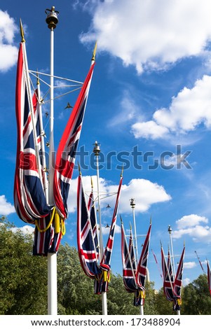 LONDON, UK - MAY 26, 2013: Multiple Union Jack flags on poles, with a beautiful sky in the background.