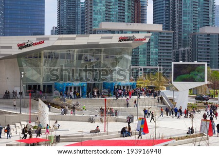 TORONTO, CANADA- 18TH MAY 2014: The outside of Ripleys Aquarium of Canada showing large amounts of people outside the building and Condos in the background