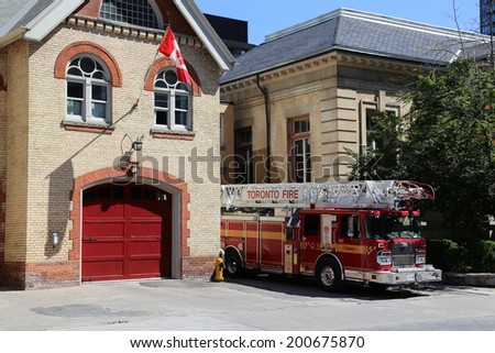 TORONTO, CANADA - 22 JUNE 2014: The outside of a Firestation in Toronto during the day with a Fire Truck parked outside