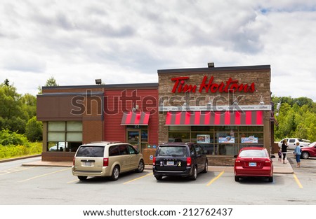 HALIFAX, CANADA  - 21ST AUGUST 2014: The outside of a Tim Hortons Restaurant during the day. People and traffic can be seen outside the restaurant.