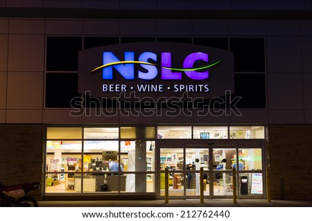 HALIFAX, CANADA  - 21ST AUGUST 2014: The outside of a Nova Scotia Liquor Store at night. People can be seen inside the store