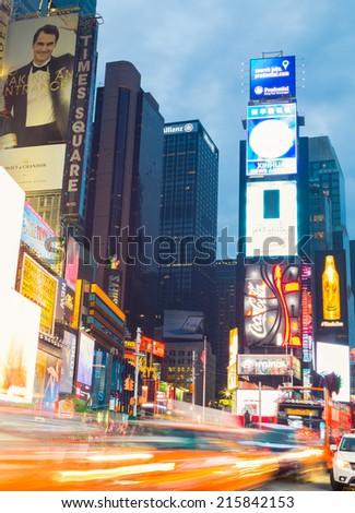 NEW YORK CITY, USA - 31ST AUGUST 2014: Time Square at Dusk showing taxis going past and billboards lit up