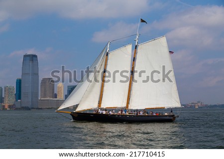 NEW YORK CITY, USA -  31ST AUGUST 2014: A boat sailing in the Hudson River near downtown New York City. People can be seen on the boat