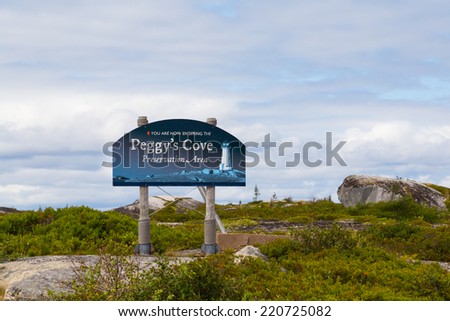 PEGGY\'S COVE, CANADA - 23RD AUGUST 2014: A sign towards the entrance to Peggy\'s Cove in Nova Scotia