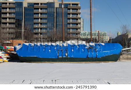 TORONTO, CANADA - 13TH JANUARY 2015: A boat covered in a plastic layer to protect it in the winter