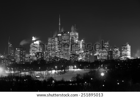 Downtown Toronto at Night in the Winter in black and white. Snow can be seen