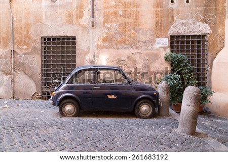 ROME, ITALY - 12TH MARCH 2015:  Small Classic Car parked up in a street in Rome