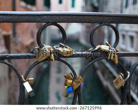VENICE, ITALY - 14TH MARCH 2015: A closeup to love locks on a bridge in Venice. The locks have writing on them and the key is missing.