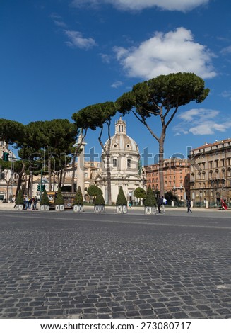 ROME, ITALY - 12TH MARCH 2015: Santissimo Nome di Maria al Foro Traiano Church and part of the Trajans Column seen through trees during the day. People can be seen on the street.