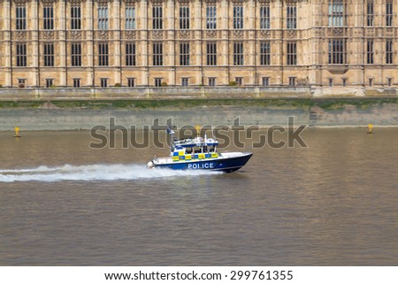 LONDON, UK - 18TH JULY 2015: A police boat along the River Thames during the day