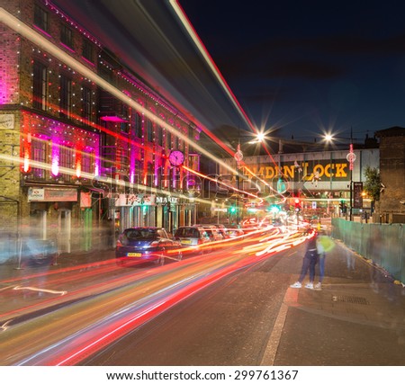 LONDON, UK - 17TH JULY 2015: The outside of buildings and a bridge in Camden Lock at night. The trails of traffic can be seen.