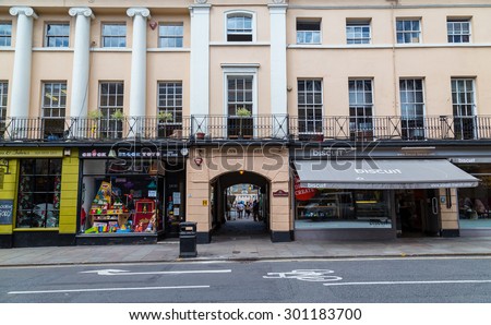LONDON, UK - 21ST JULY 2015: Buildings and shops along Nelson Road in London. People can be seen.