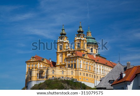 The outside of Melk Abbey in Austria during the day in the summer. There is space for text.