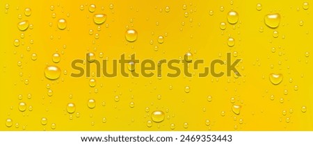 Condensation of water or beer droplets on glass, abstract wet yellow champagne or juice background, backdrop made of rain drops.